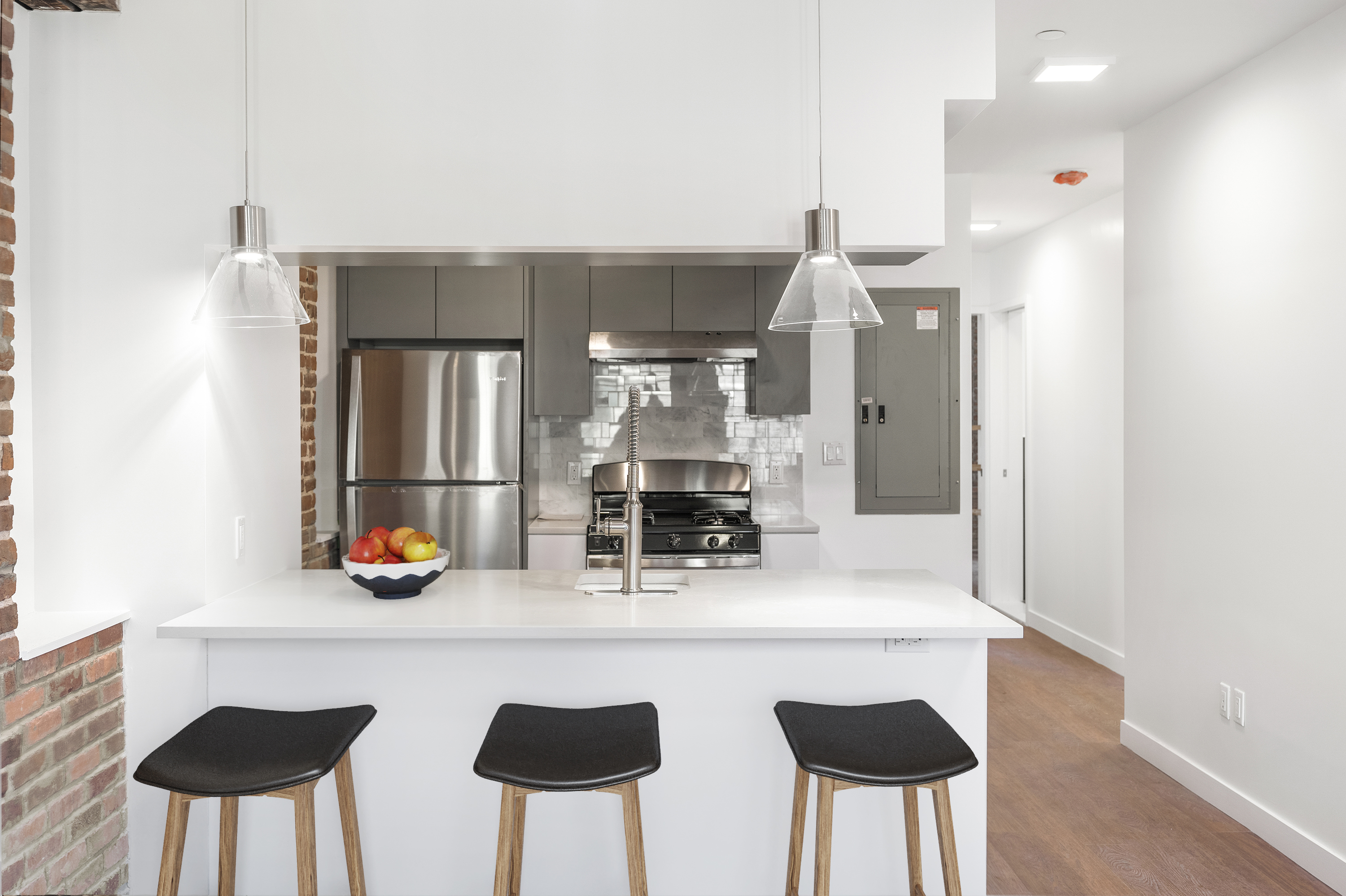 406 West 52nd Street, Unit 1 Manhattan, NY 10019 - Photo 3 of 9 a kitchen with a table and chairs