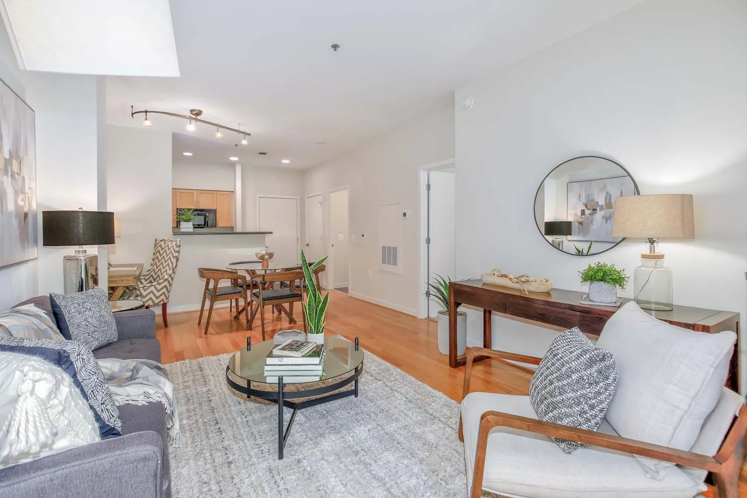 a living room with furniture and a dining table