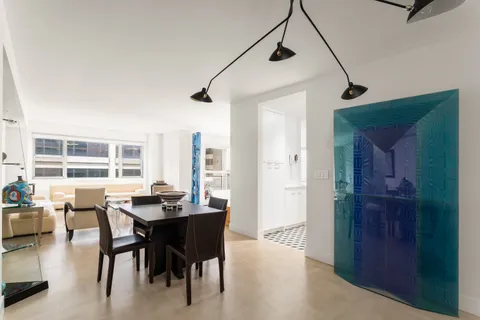 a view of a dining room with furniture and window