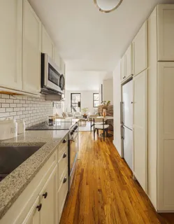 a kitchen with granite countertop a sink appliances and cabinets