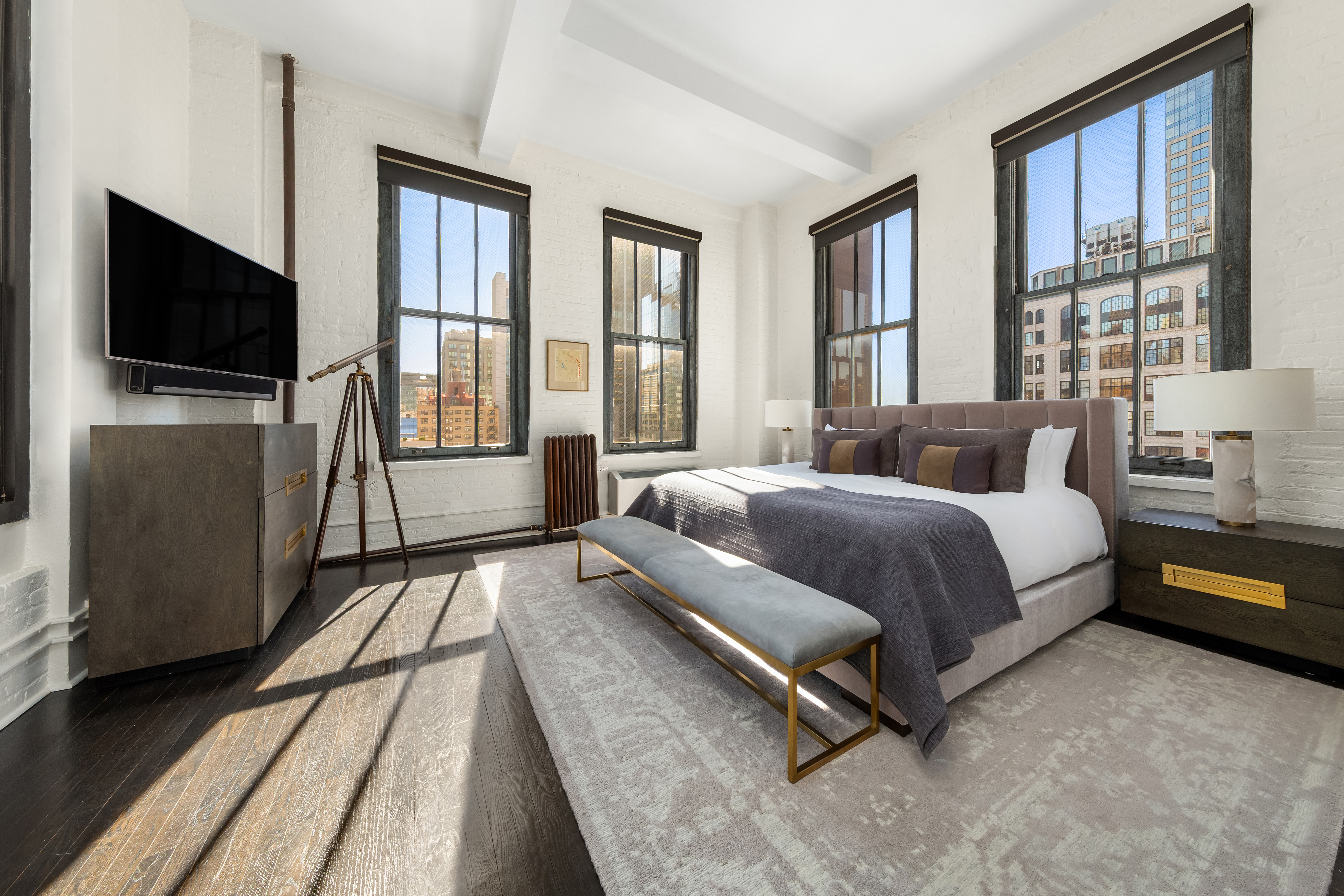 448 West 37th Street, Unit 11G/12G Manhattan, NY 10018 - Photo 10 of 17 a spacious bedroom with a bed and flat screen tv