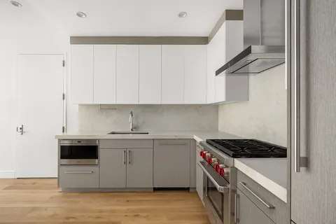 a kitchen with stainless steel appliances granite countertop a sink and a stove