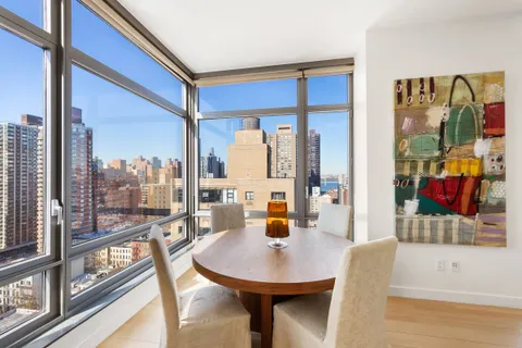 a view of a living room with a table and chairs