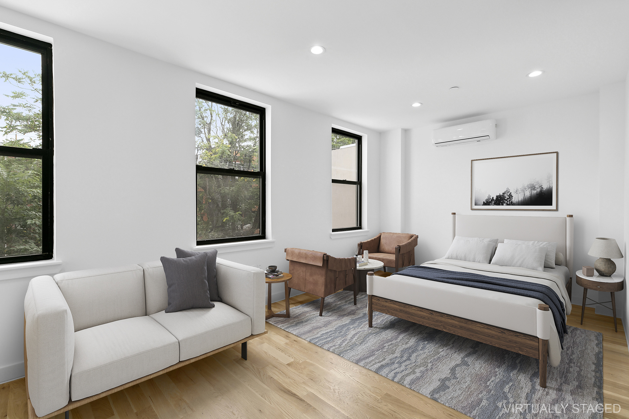 a spacious bedroom with a bed a couch and a window