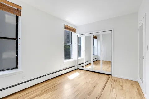 a view of room with window and wooden floor