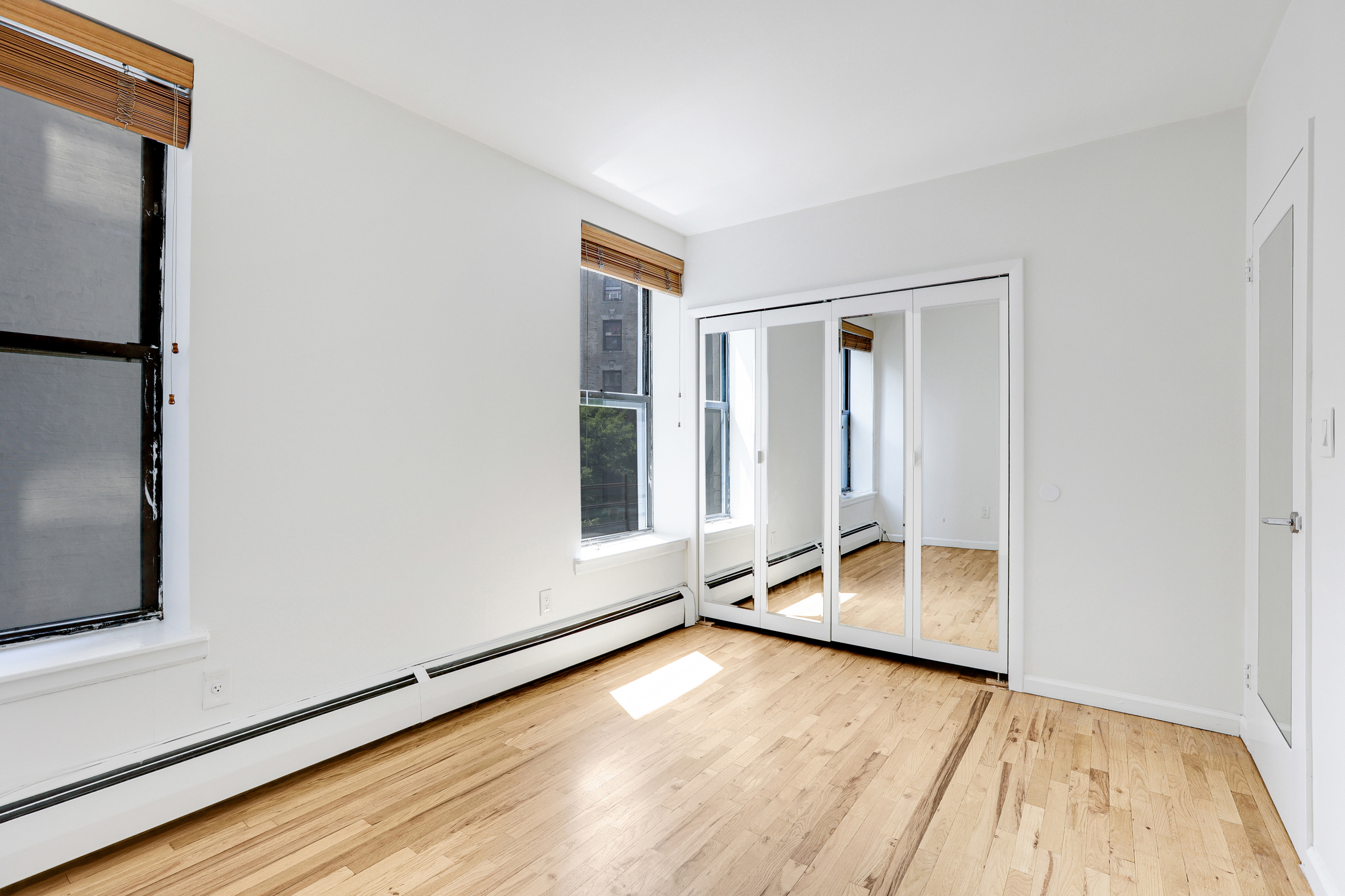 66-72 St Nicholas Avenue, Unit 3G Manhattan, NY 10026 - Photo 9 of 15 a view of room with window and wooden floor