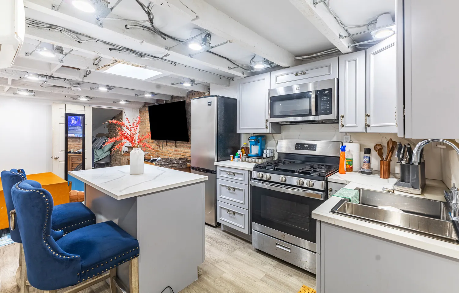 a kitchen with stainless steel appliances granite countertop a sink a stove and a refrigerator