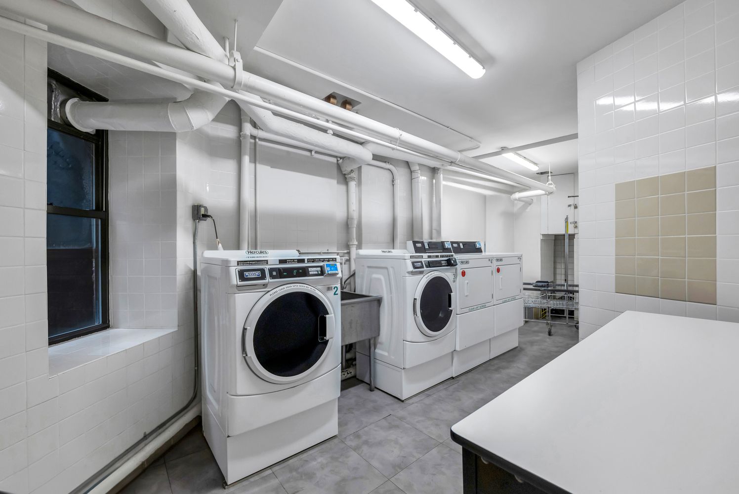 223 West 10th Street, Unit 2C Manhattan, NY 10014 - Photo 9 of 11 a utility room with dryer and washer