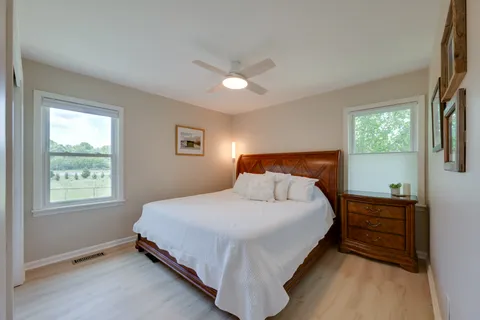 a bedroom with a bed and a chandelier
