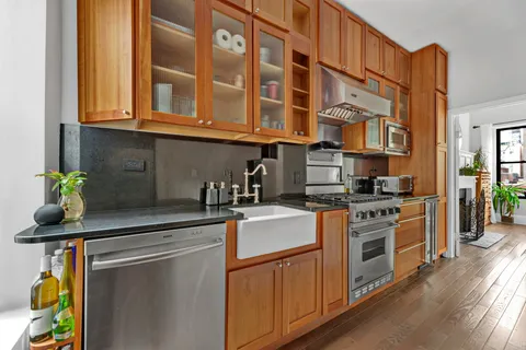a kitchen with stainless steel appliances granite countertop a stove and a sink