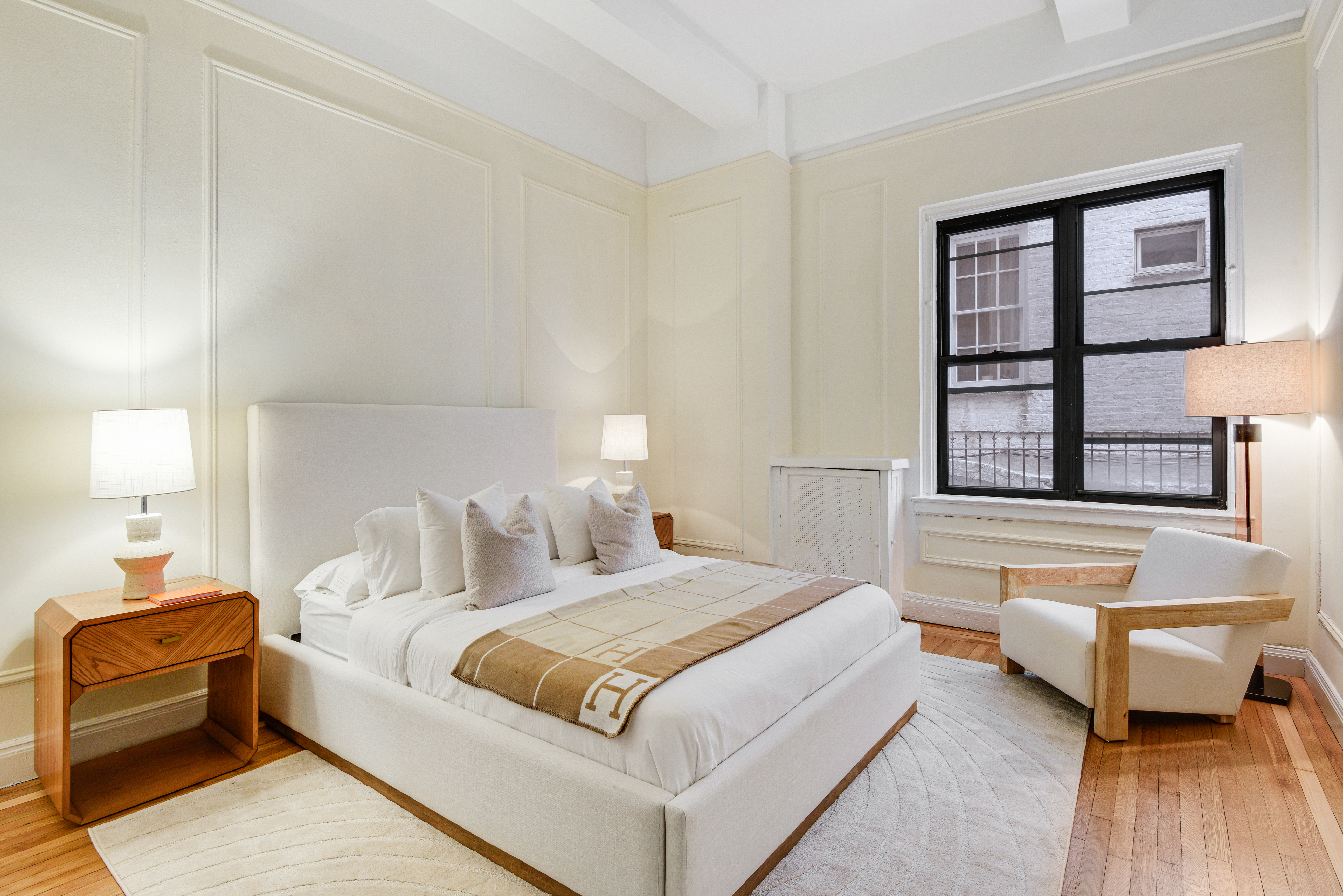 1349 Lexington Avenue, Unit 1F Manhattan, NY 10128 - Photo 4 of 16 a bedroom with a bed and wooden floor