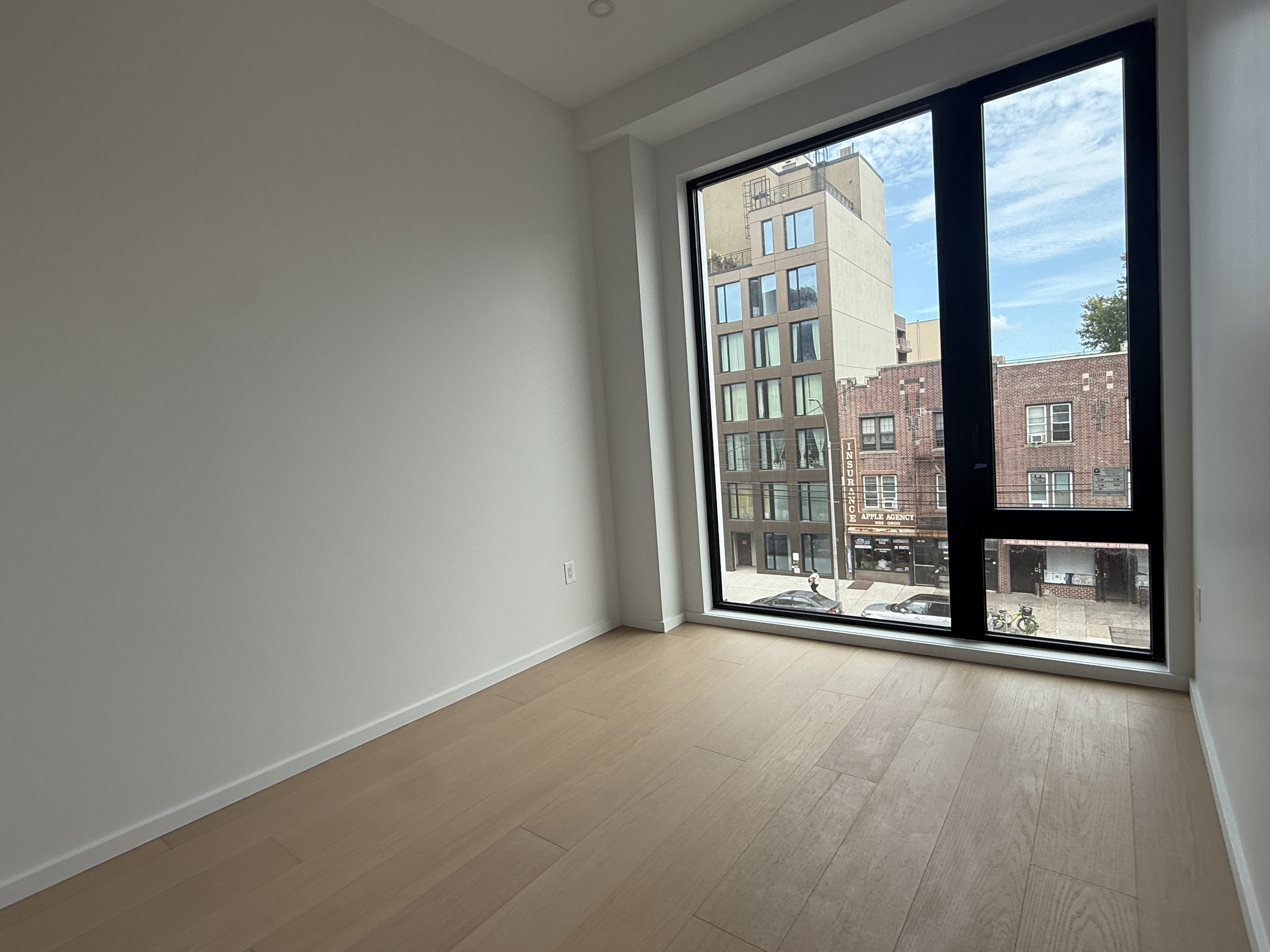 31-16 21st Street, Unit 3E Queens, NY 11106 - Photo 5 of 17 a view of an empty room with a window