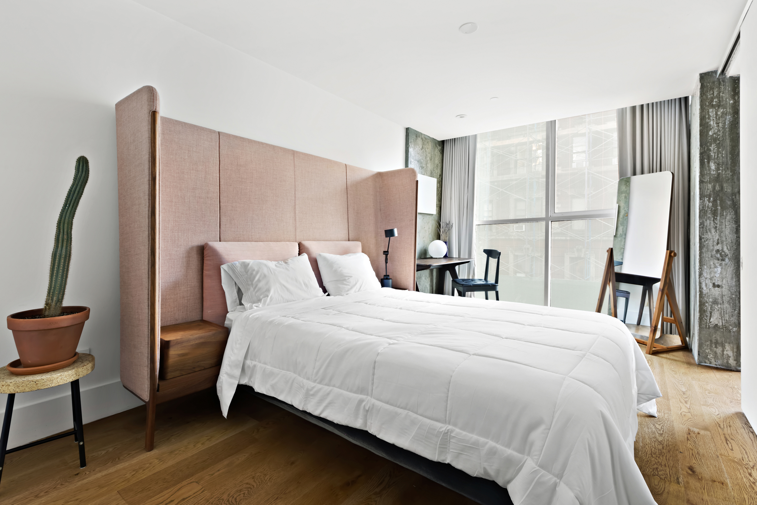 115 Norfolk Street, Unit 304 Manhattan, NY 10002 - Photo 8 of 15 a bedroom with a bed wooden floor and a large window