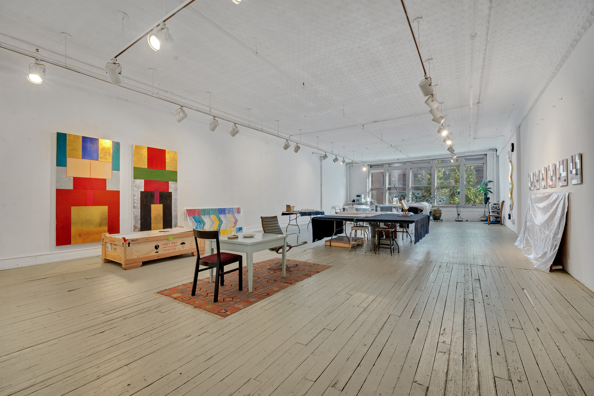 69 Wooster Street, Unit 3 Manhattan, NY 10012 - Photo 17 of 22 a living room with furniture and wooden floor