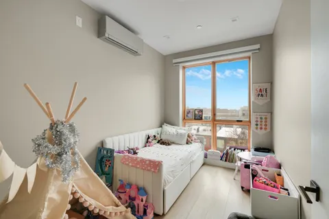 a bedroom with a bed and a potted plant