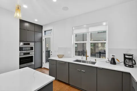 a kitchen with stainless steel appliances a sink stove and cabinets