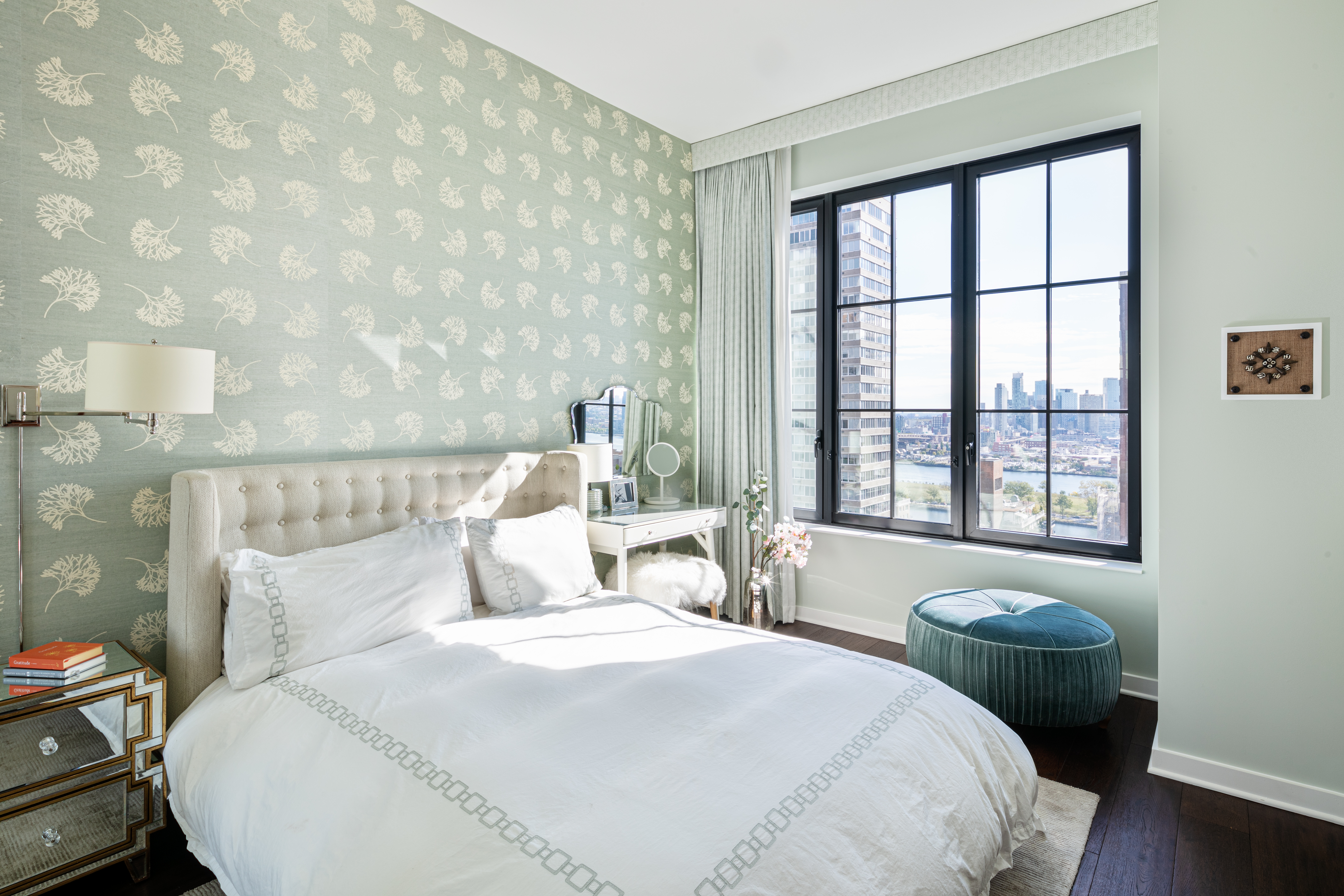 959 1st Avenue, Unit 22E Manhattan, NY 10022 - Photo 4 of 8 a bedroom with a bed and a window with chair