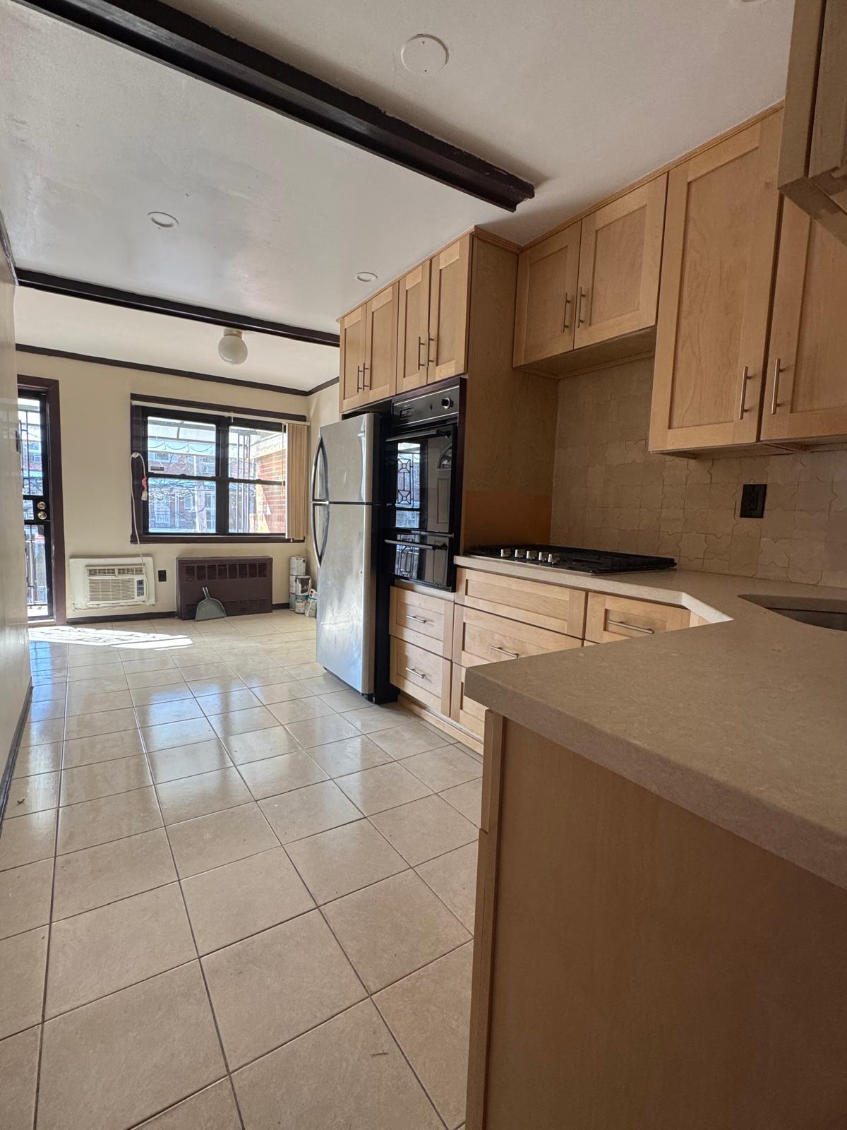 647 East 82nd Street, Unit 2 Brooklyn, NY 11236 - Photo 3 of 6 a kitchen with stainless steel appliances a stove refrigerator sink and cabinets