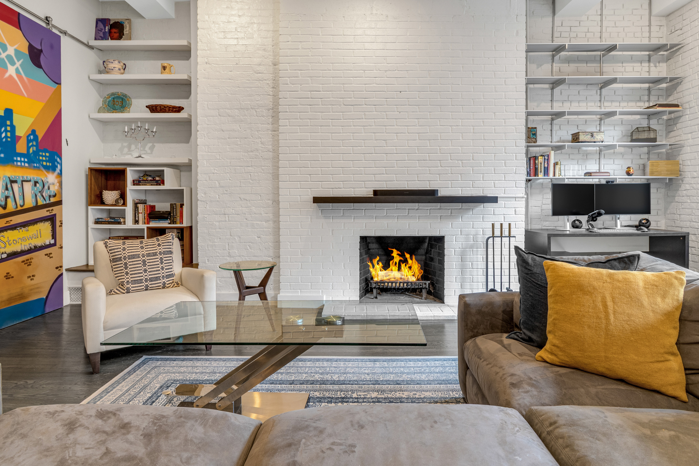 521 West 47th Street, Unit 3A Manhattan, NY 10036 - Photo 3 of 13 a living room with furniture and a fireplace