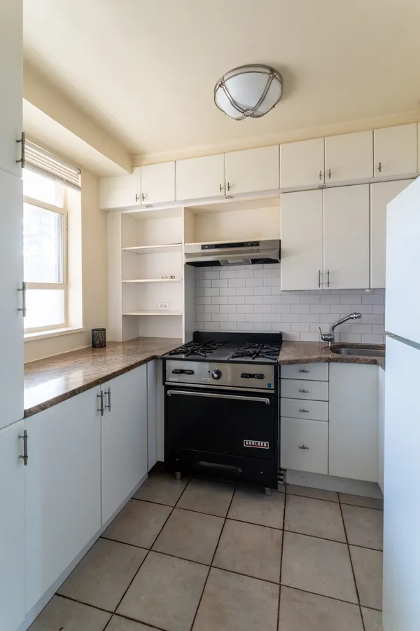 a kitchen with cabinets and appliances