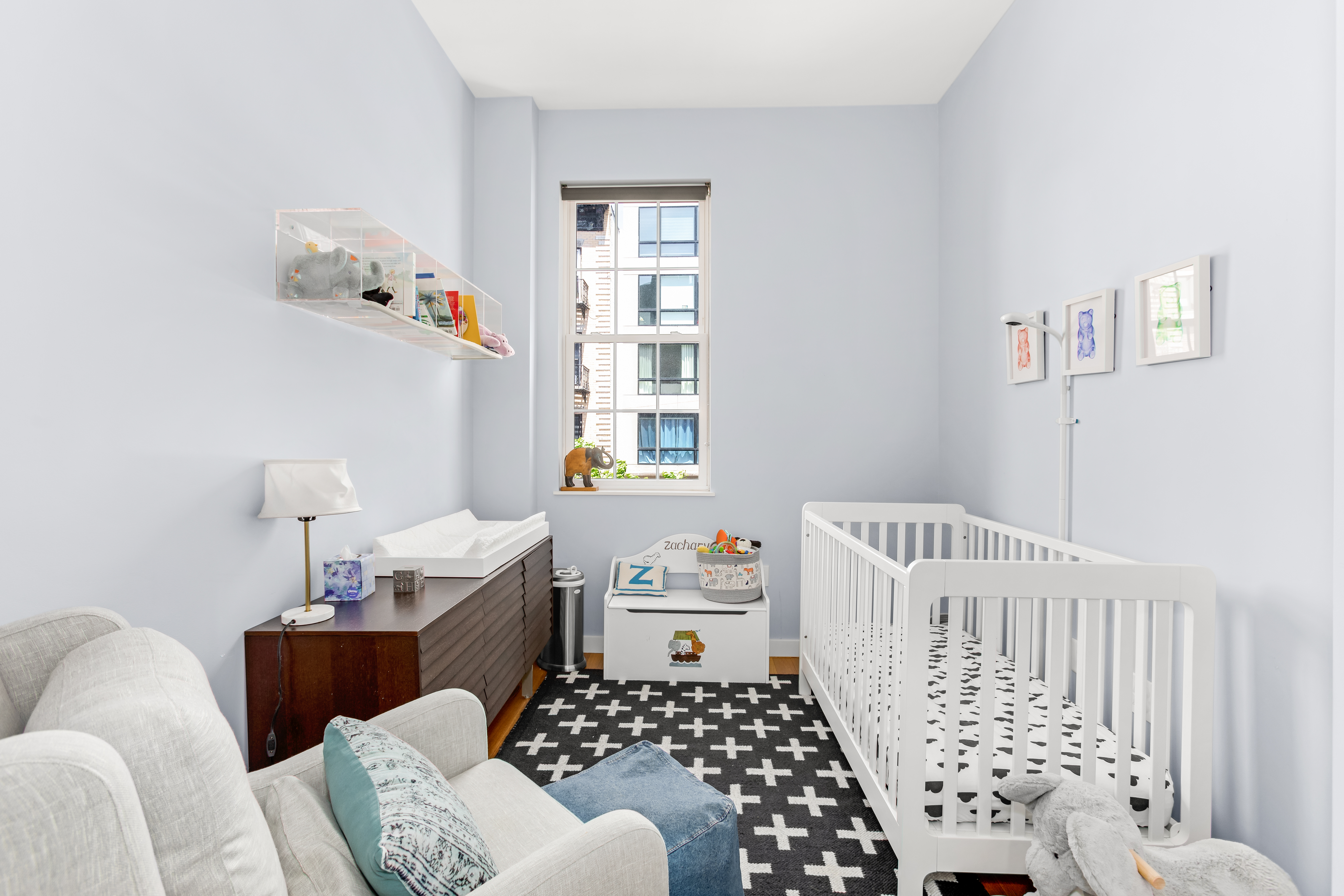 324 20th Street, Unit 2E Brooklyn, NY 11215 - Photo 9 of 11 a bedroom with a baby bed a couch and a window