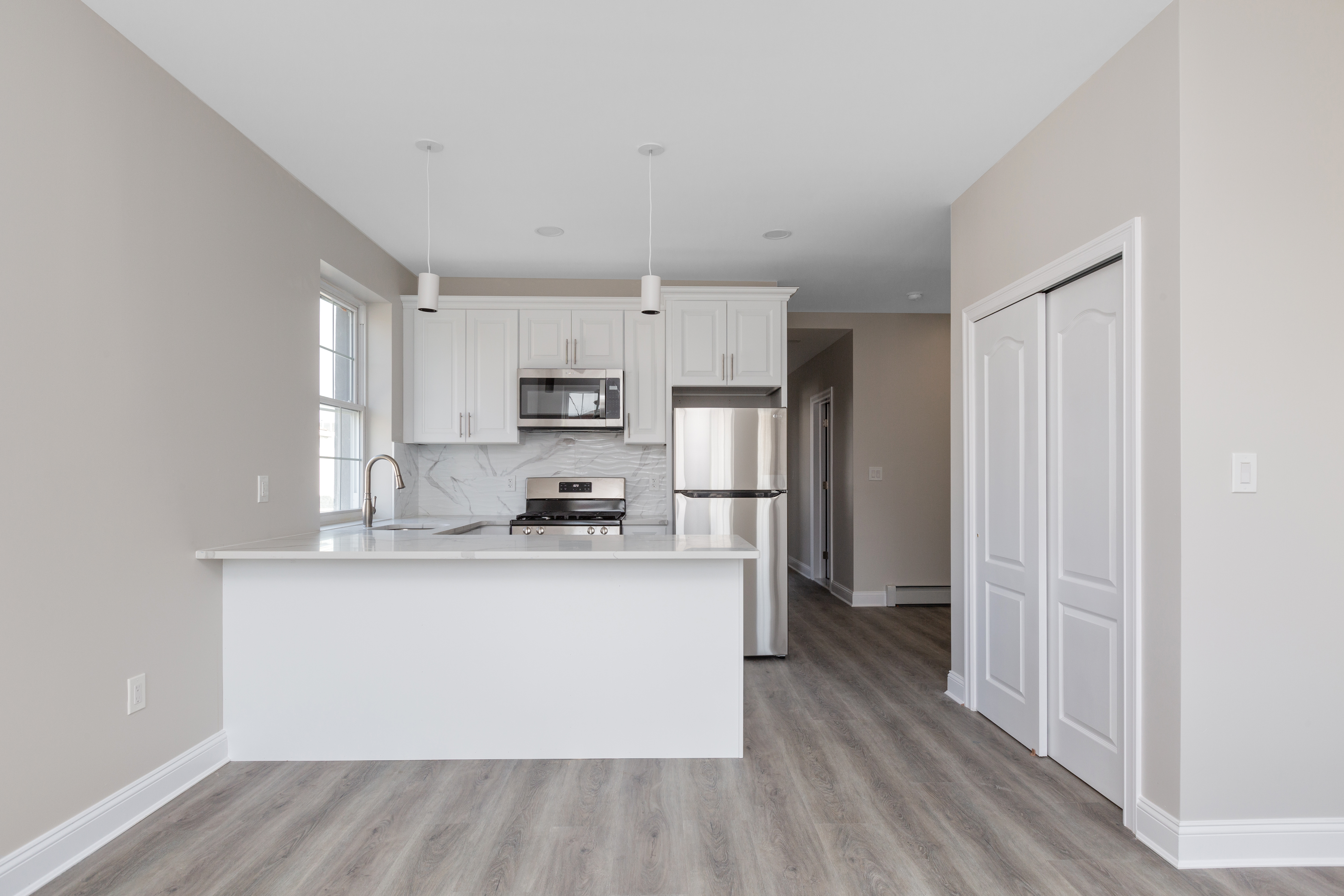 143-10 Shore Avenue Queens, NY 11435 - Photo 2 of 30 a kitchen with stainless steel appliances a refrigerator and a stove top oven