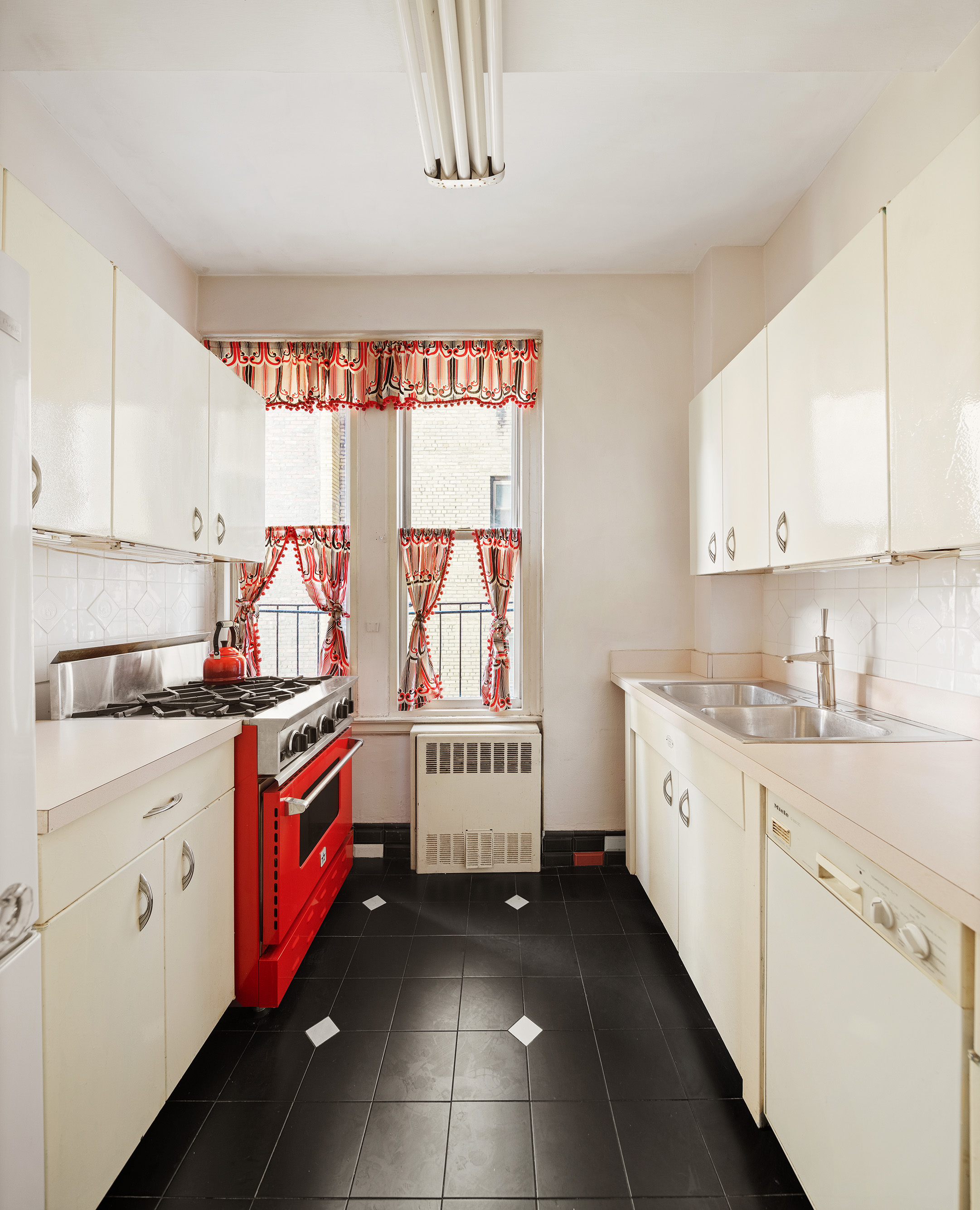45 Gramercy Park North, Unit 4B Manhattan, NY 10010 - Photo 8 of 13 a kitchen with granite countertop a stove sink and cabinets