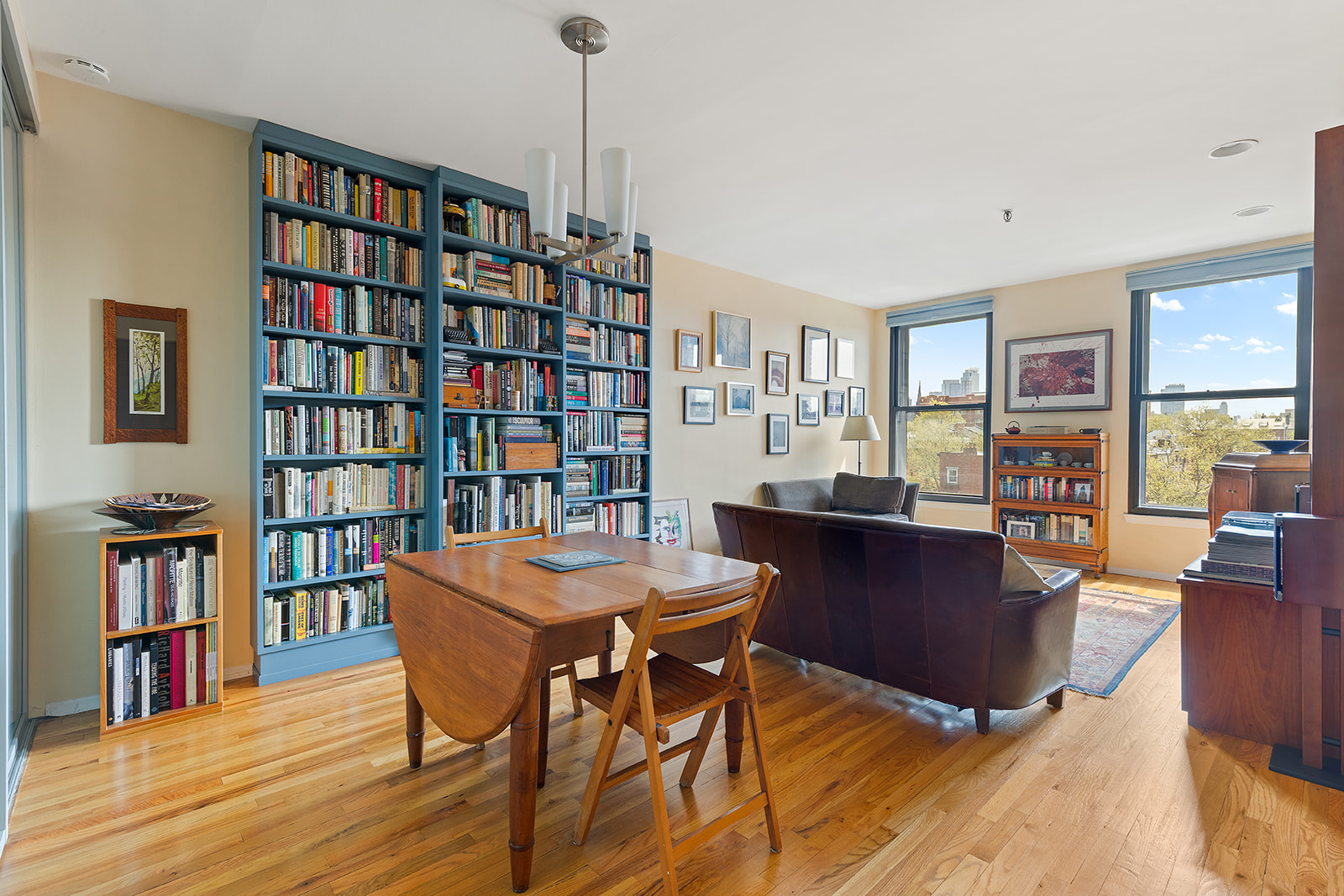 a living room with furniture and a book shelf