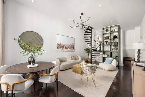 a view of a dining room with furniture and chandelier