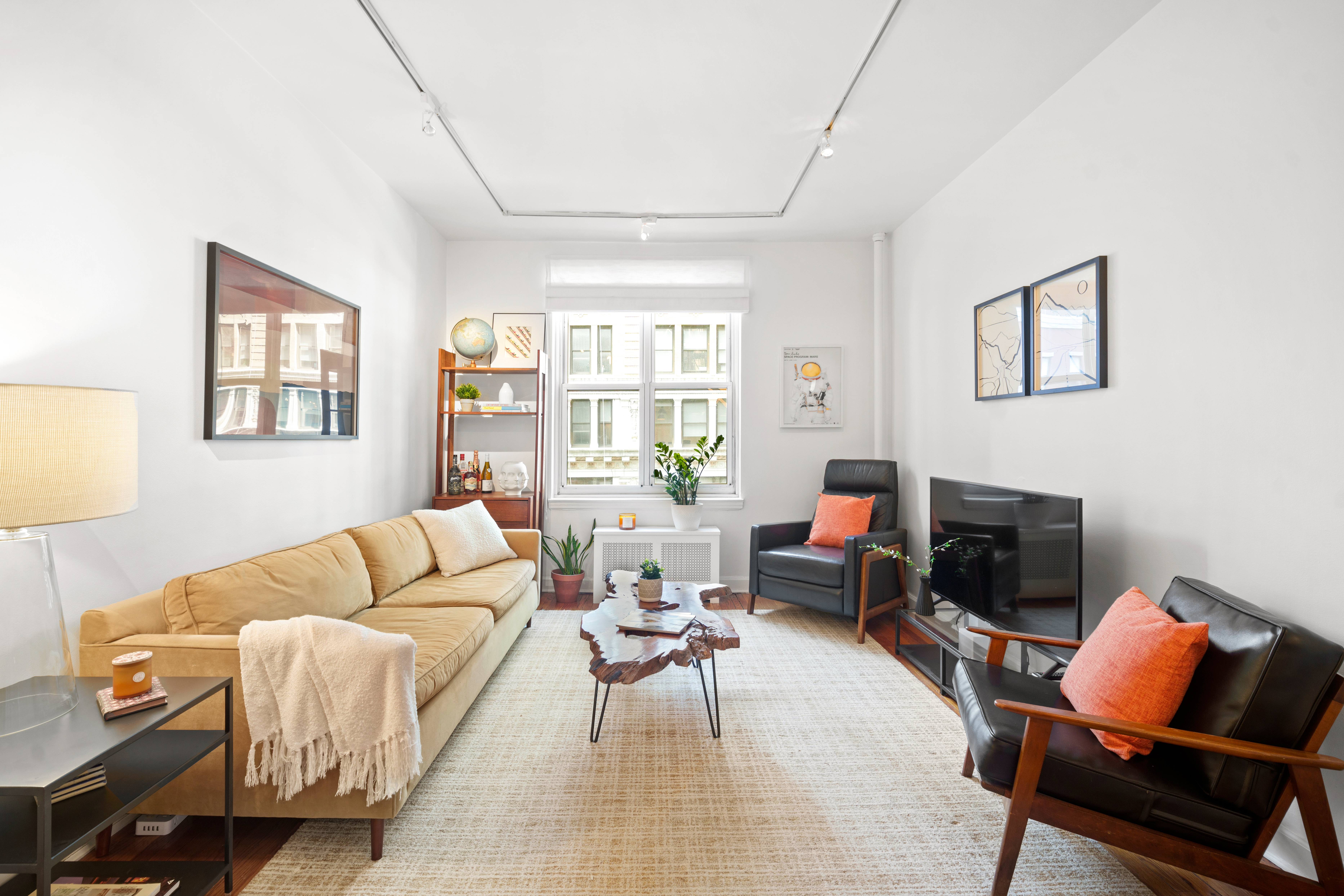 22 Irving Place, Unit 4E Manhattan, NY 10003 - Photo 1 of 8 a living room with furniture and a fireplace