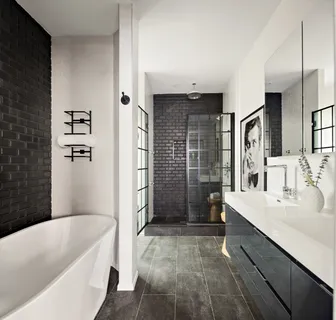 a bathroom with a tub a sink and a shower
