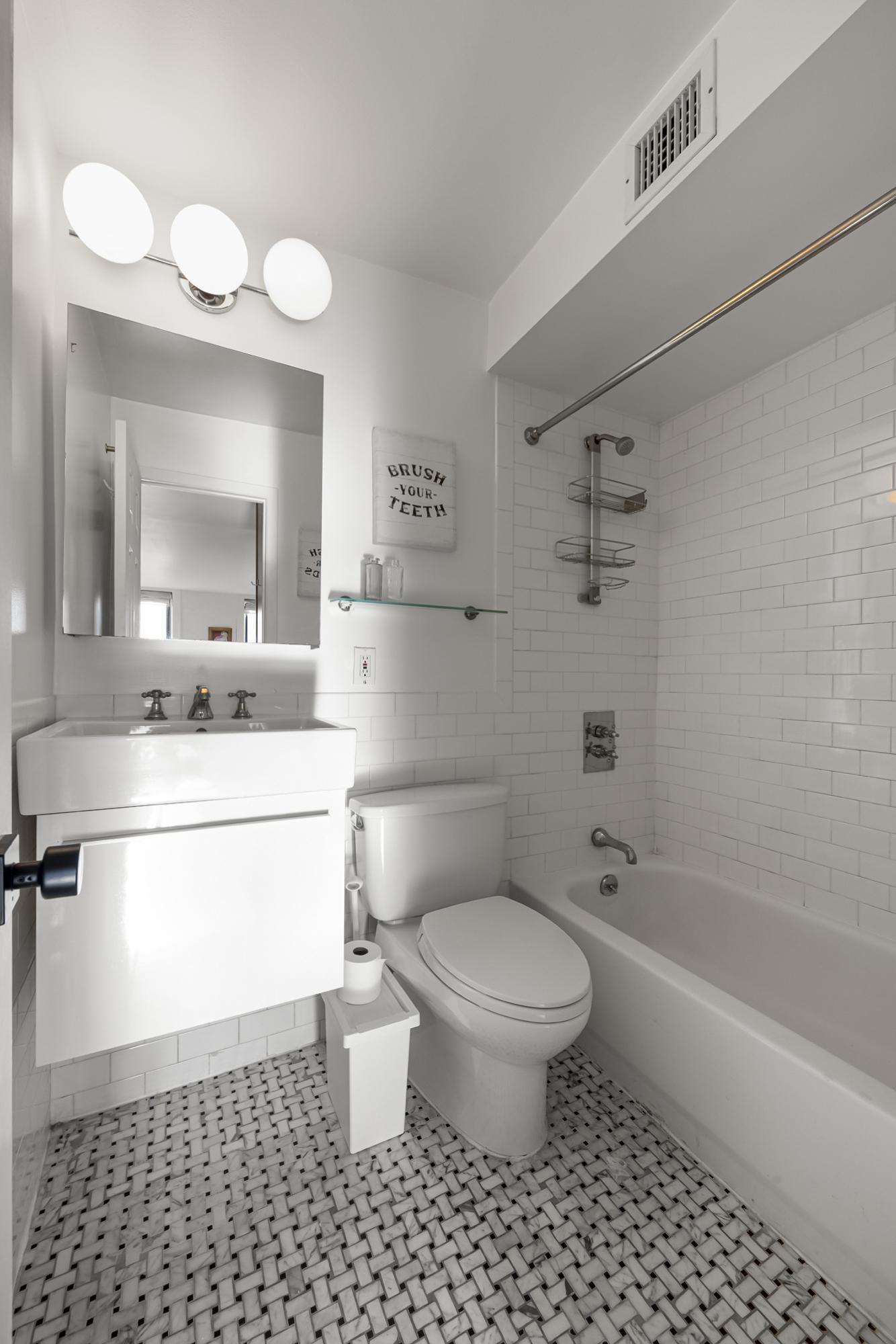 504 East 6th Street, Unit 5 Manhattan, NY 10009 - Photo 10 of 11 a bathroom with a sink a toilet and shower