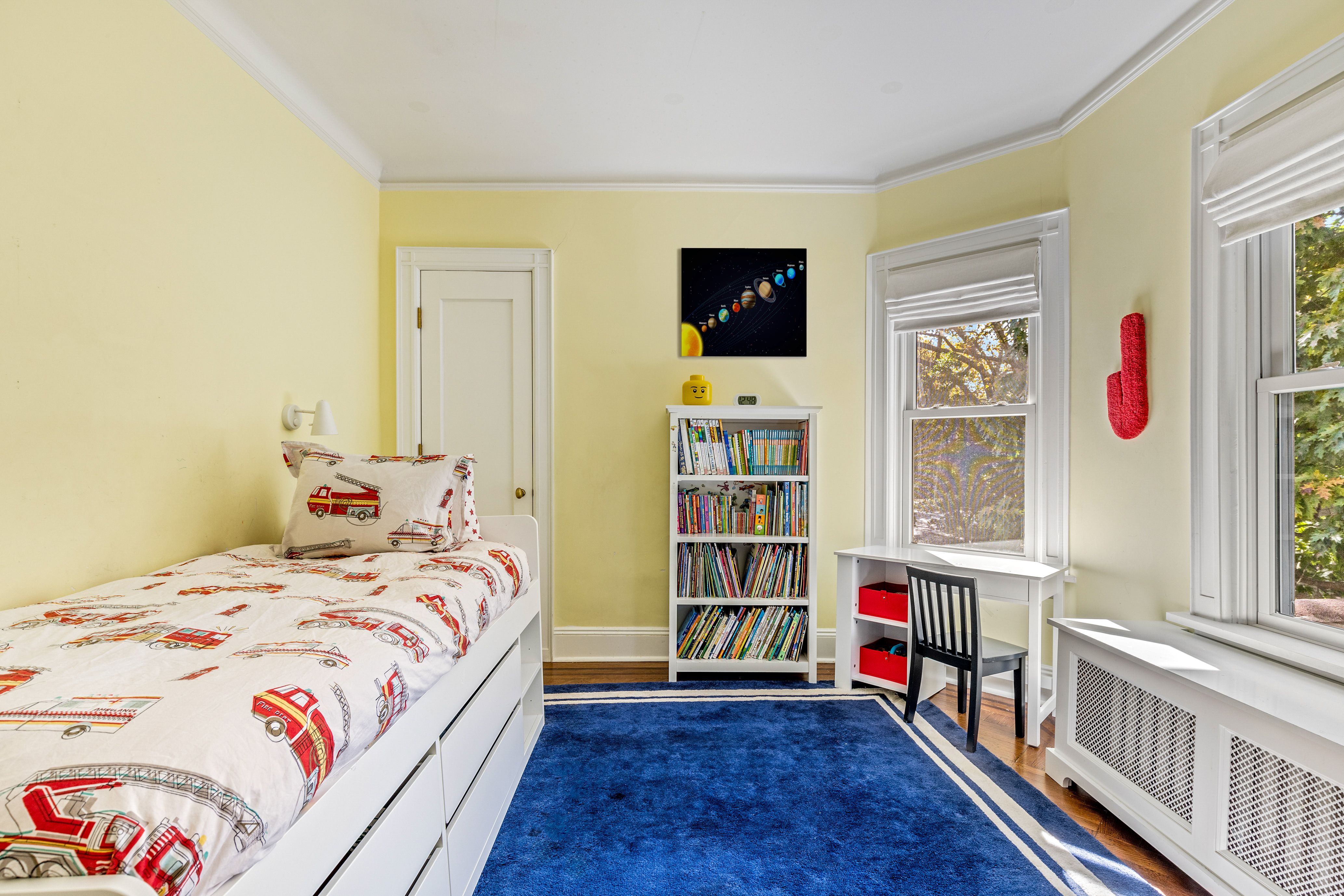 689 East 17th Street Brooklyn, NY 11230 - Photo 21 of 28 a bedroom with a bed and a book shelf