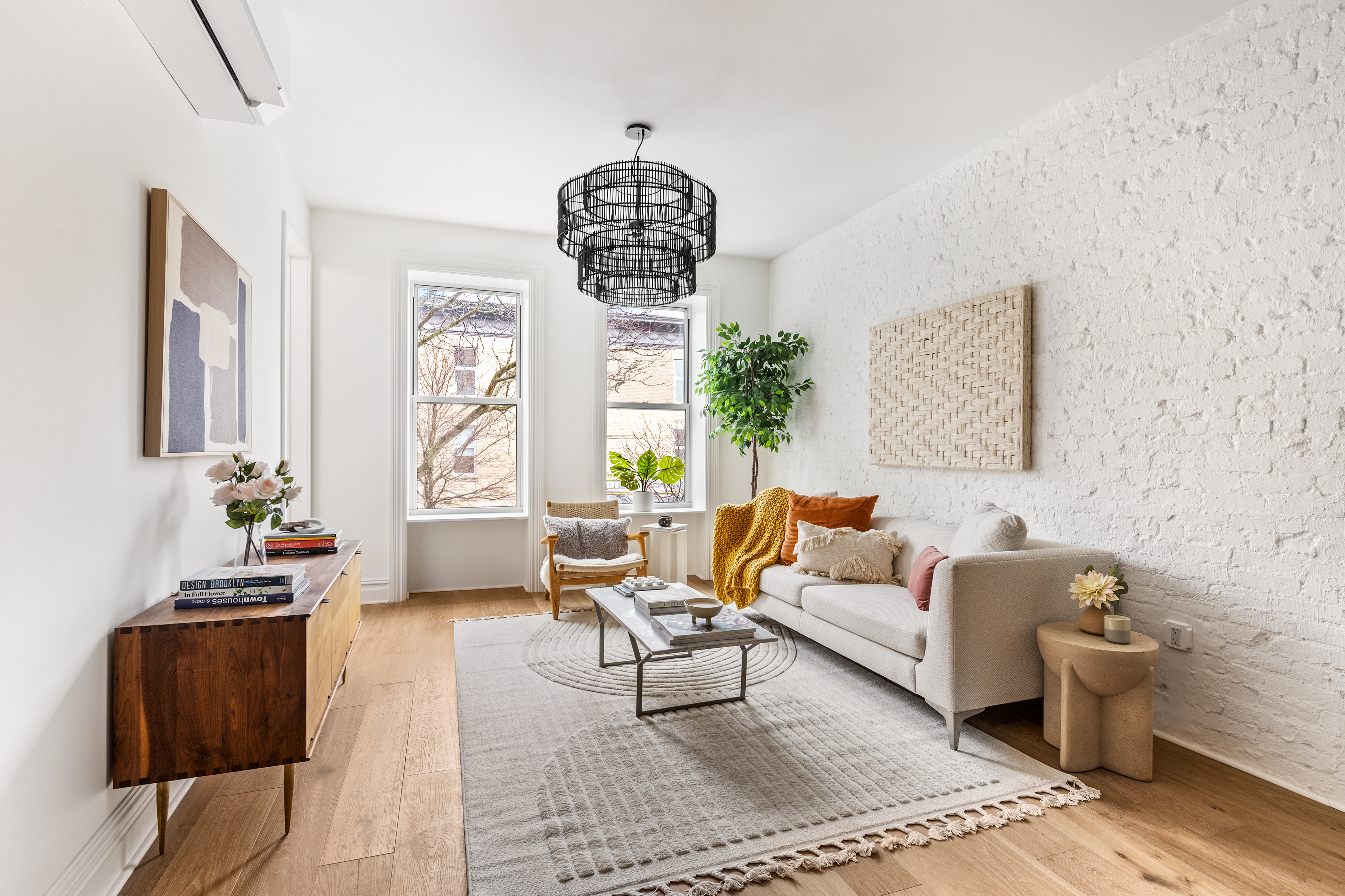 a living room with furniture chandelier and a window