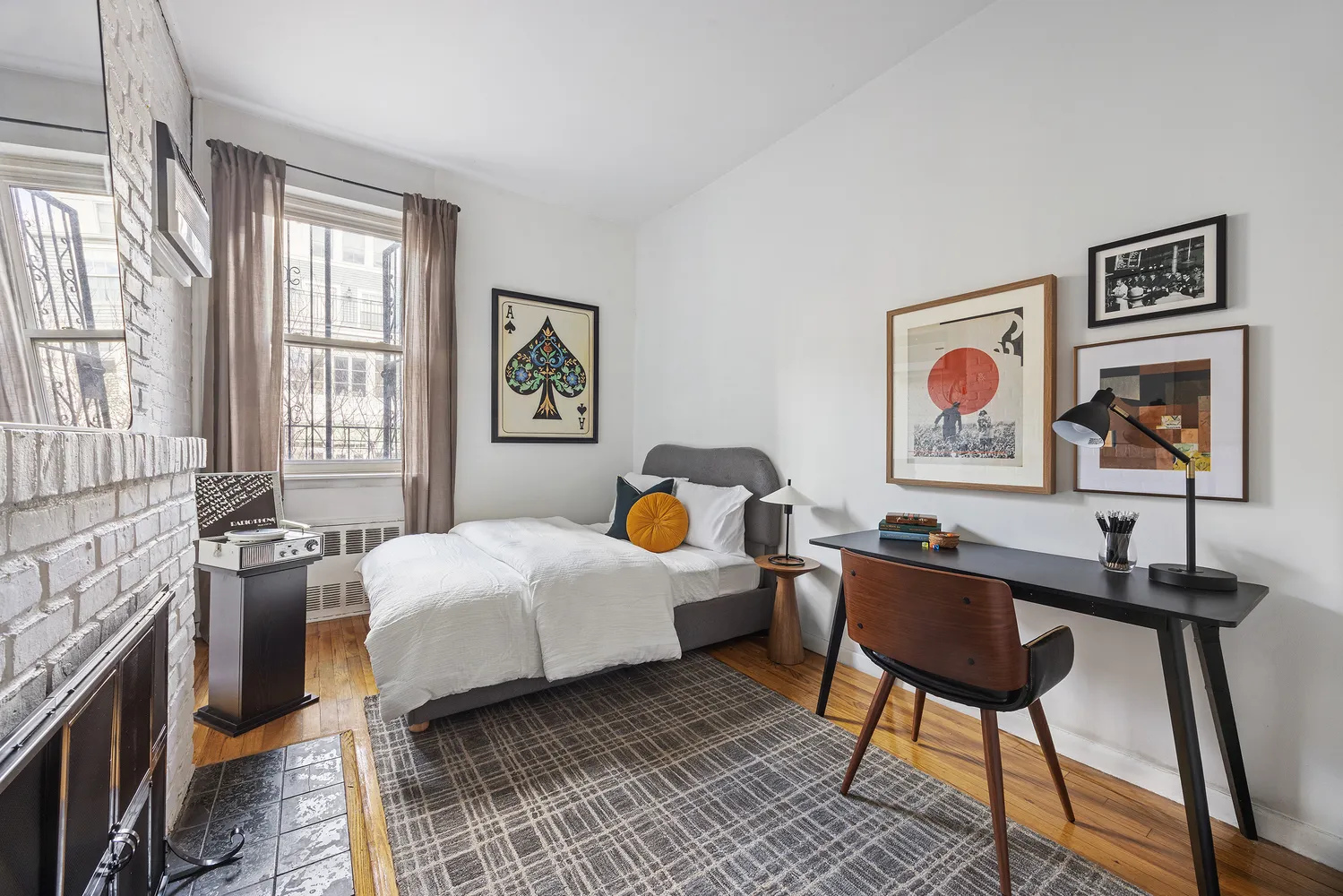 a bedroom with a bed and a workspace