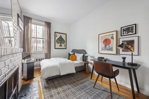 a bedroom with a bed and a workspace