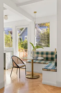 a living room with a table and a large window