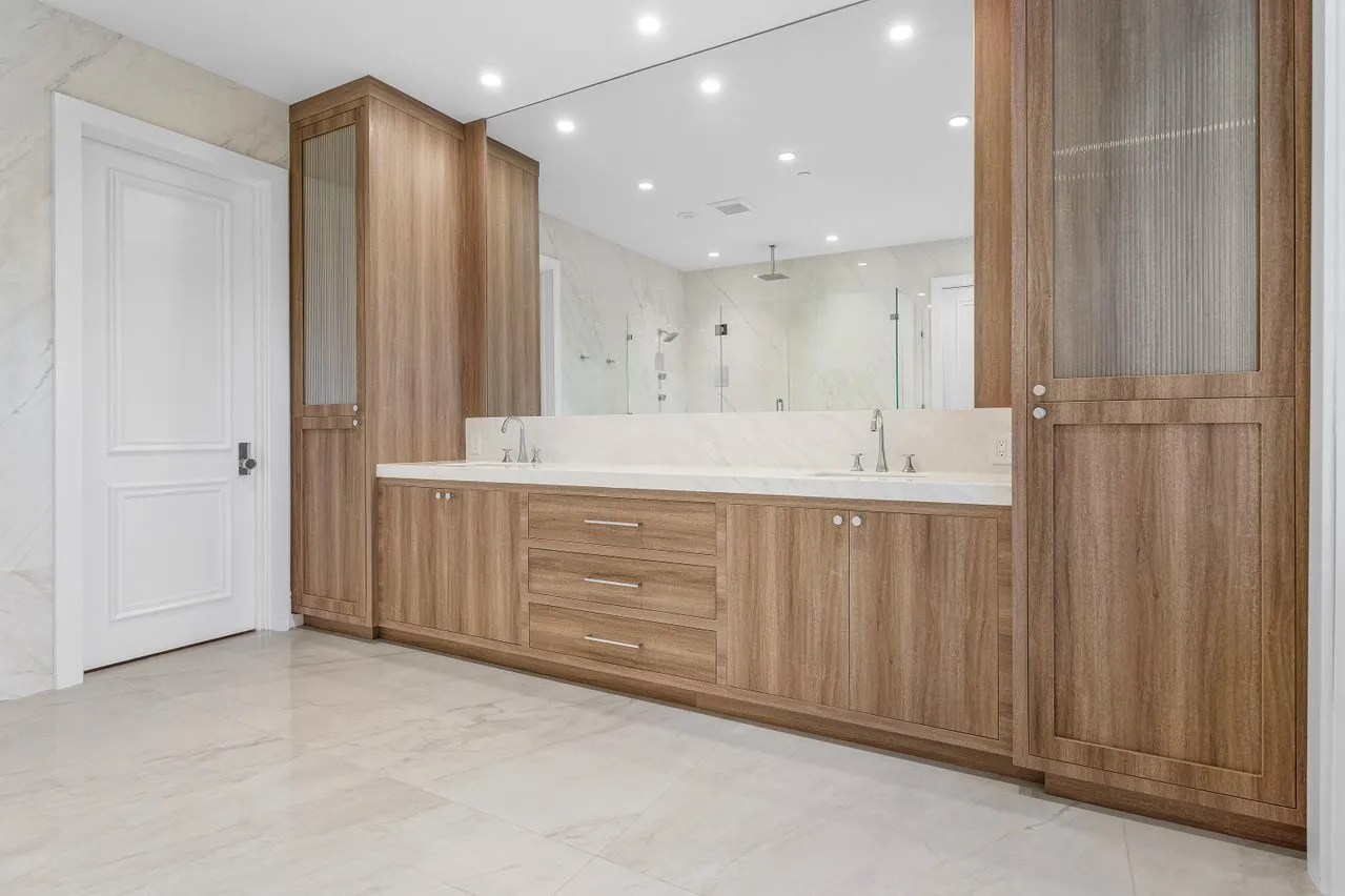 a bathroom with a double vanity sink and a mirror