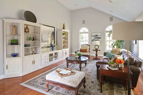 a living room with furniture and wooden floor