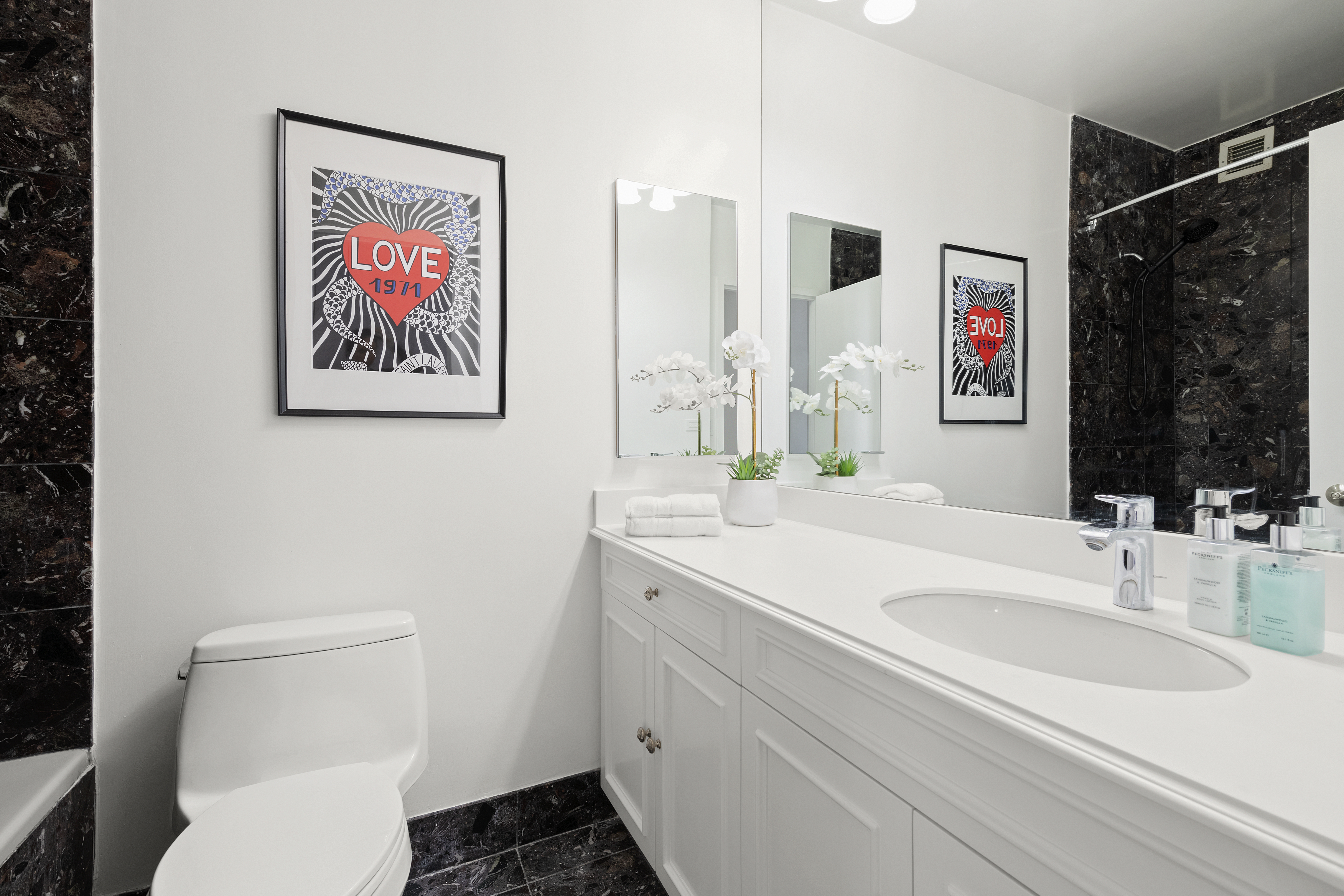 304 East 65th Street, Unit 6D Manhattan, NY 10065 - Photo 7 of 15 a bathroom with a sink and a mirror