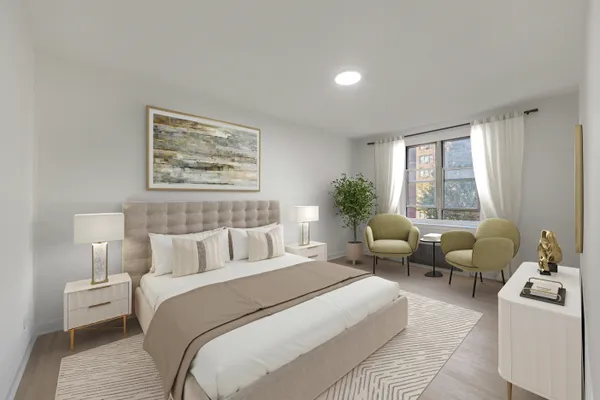 a bedroom with bed couch and window