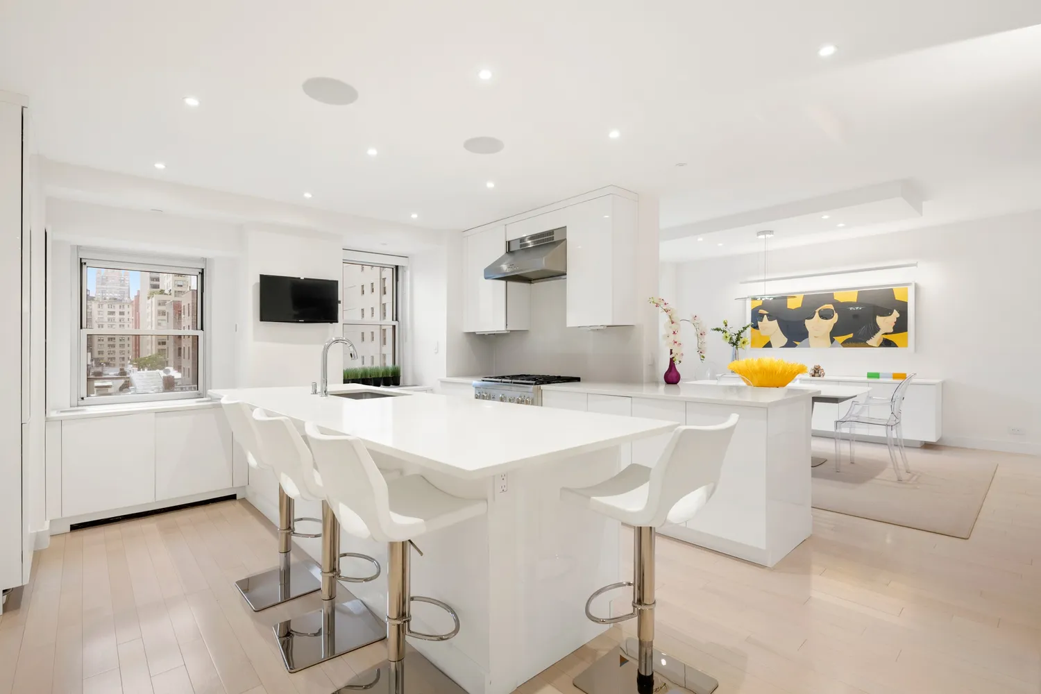 a kitchen with stainless steel appliances kitchen island granite countertop a sink and chairs