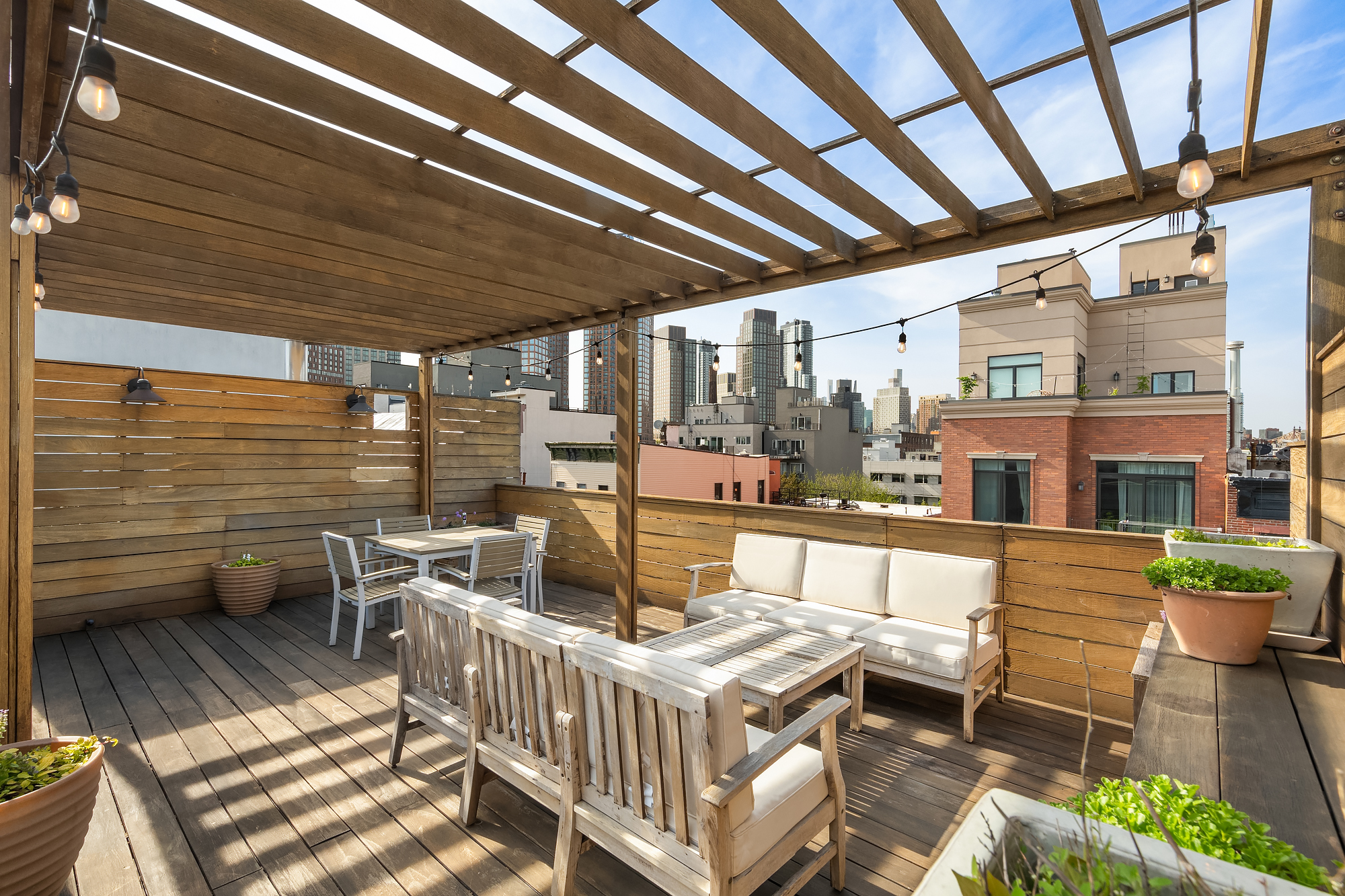 102 Clay Street, Unit 4 Brooklyn, NY 11222 - Photo 11 of 13 a view of a patio with couches chairs and wooden floor