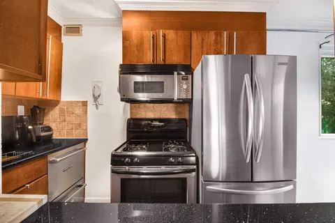 a kitchen with a stove and a refrigerator