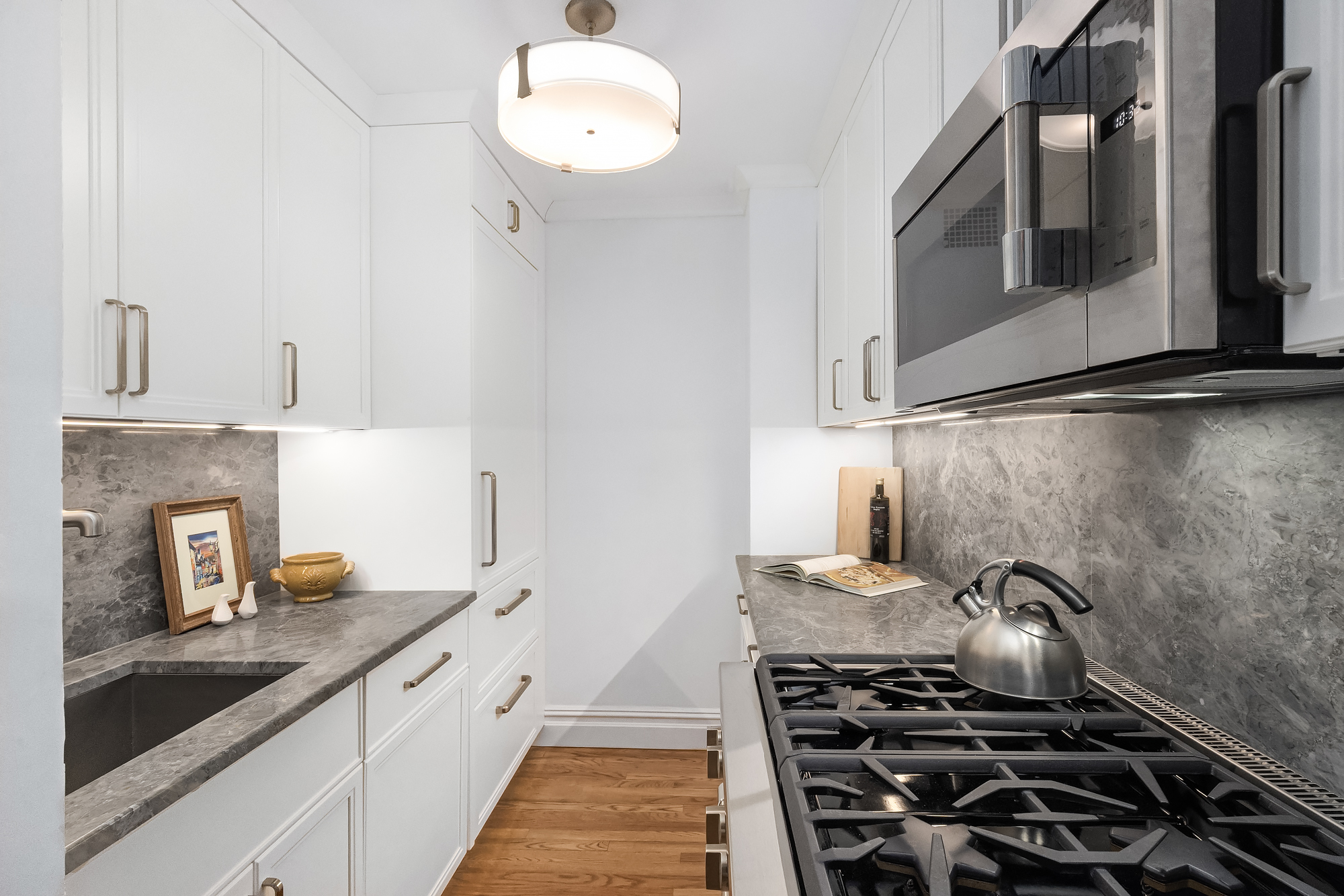 101 West 12th Street, Unit 8N Manhattan, NY 10011 - Photo 7 of 17 a kitchen with a stove and a sink