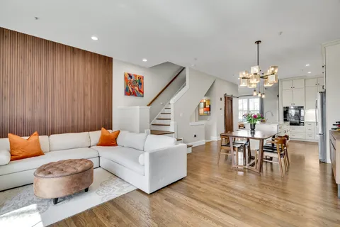 a living room with furniture and a chandelier