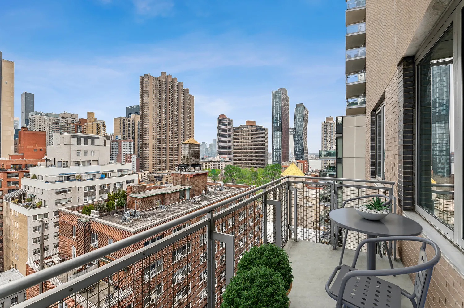 a view of balcony with chairs and iron fence