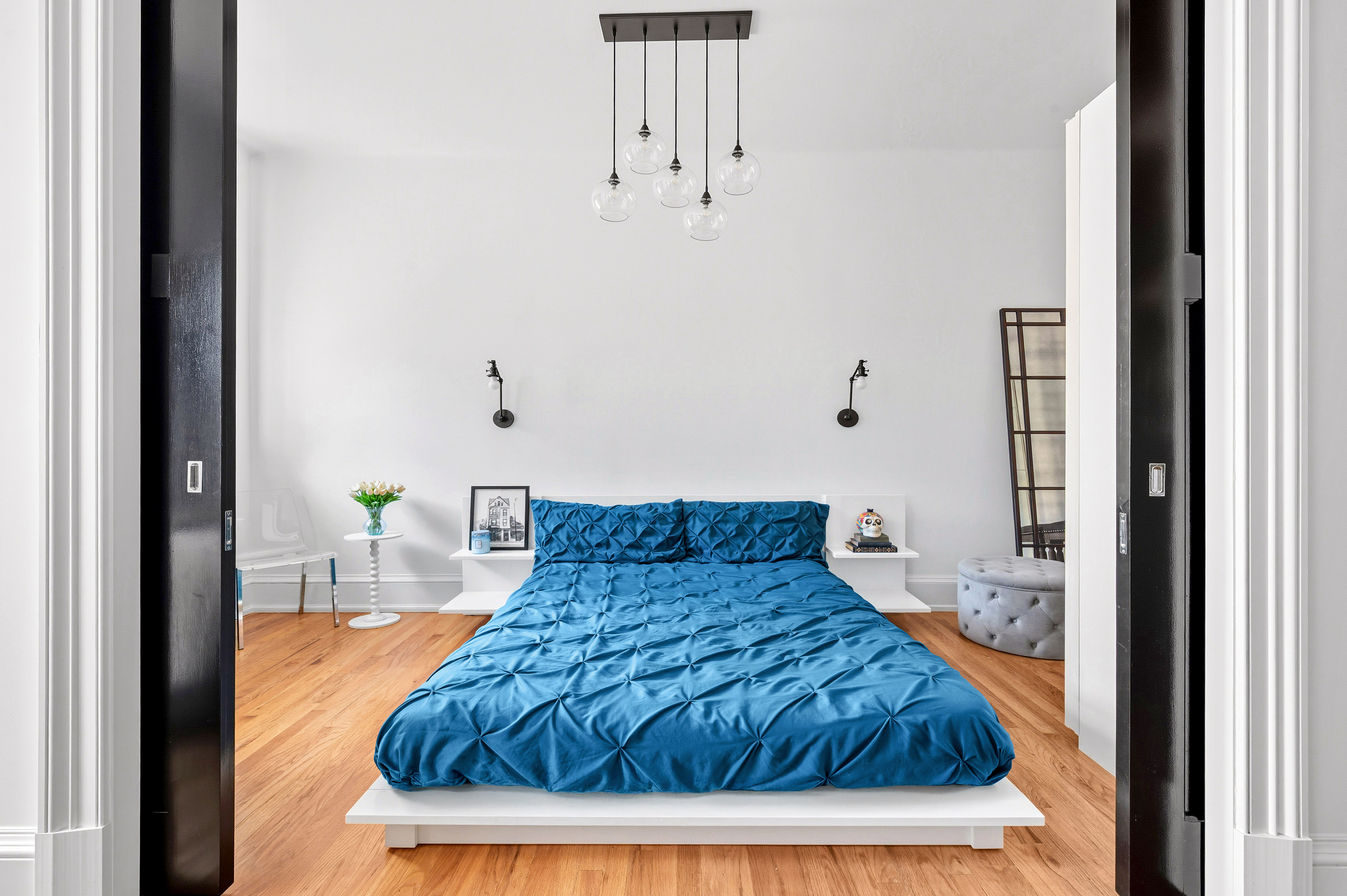 308 West 106th Street, Unit 4R Manhattan, NY 10025 - Photo 5 of 10 a bedroom with a bed table and a chandelier