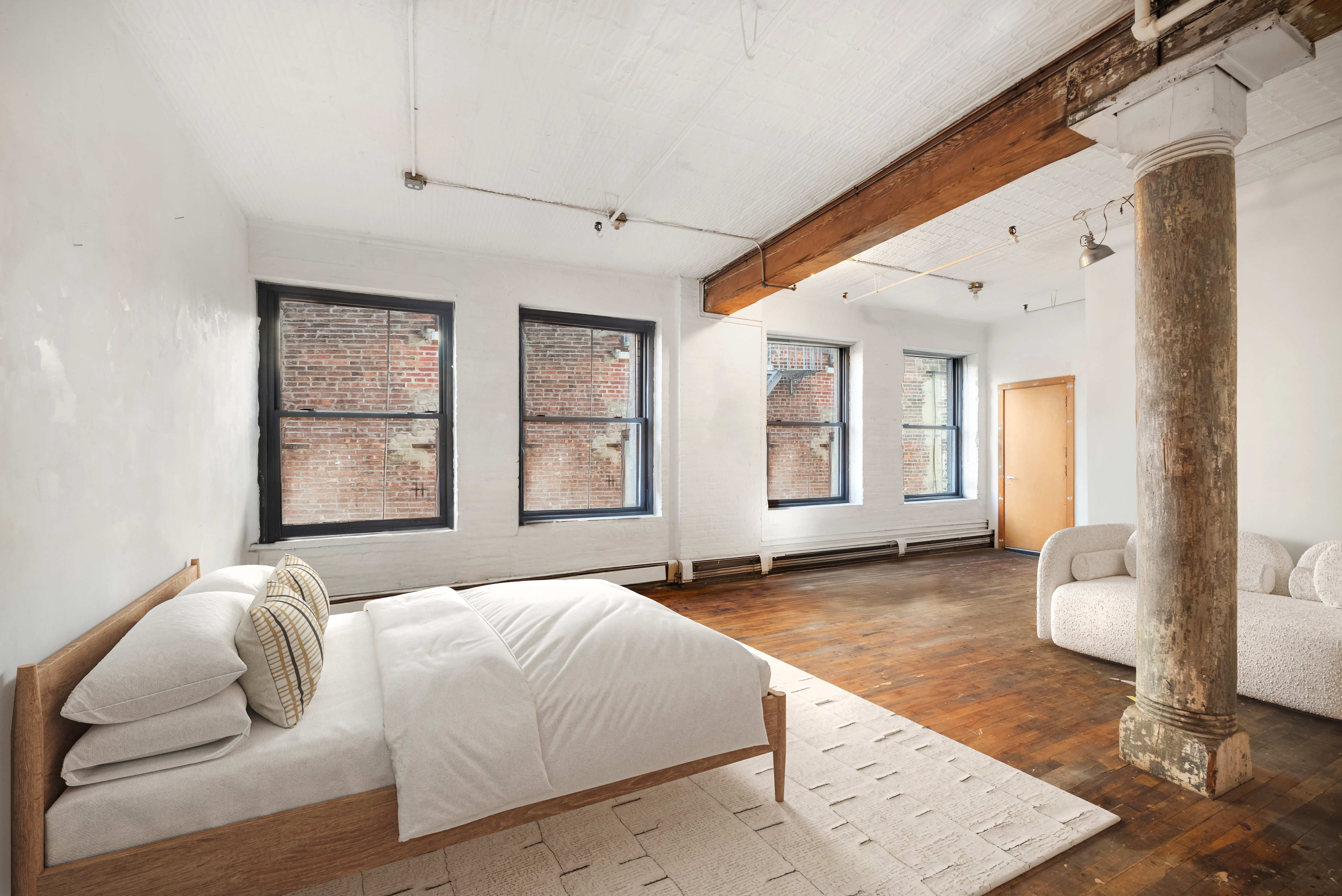 27 Bleecker Street, Unit 6B Manhattan, NY 10012 - Photo 4 of 7 a spacious bedroom with a large bed and a window