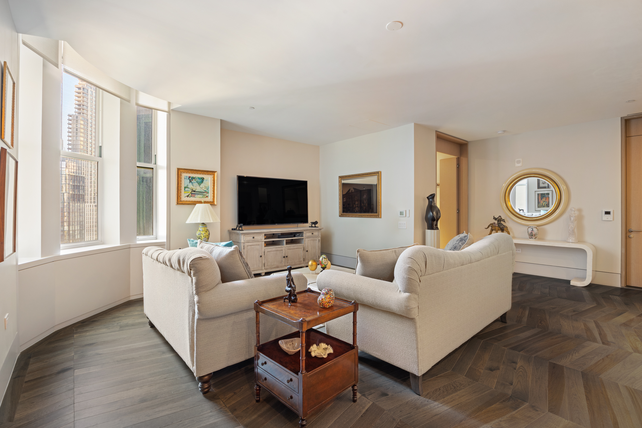49 Chambers Street, Unit 14C Manhattan, NY 10007 - Photo 2 of 26 a living room with furniture and a flat screen tv
